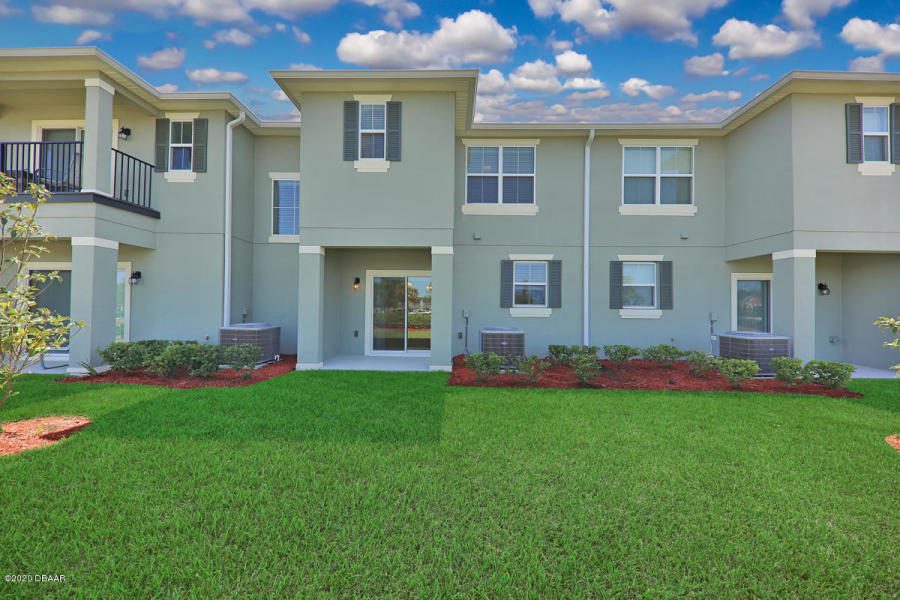 An image of townhouses and beautiful lawn outside it.Oceans Managing Group can provide property management for a property like this