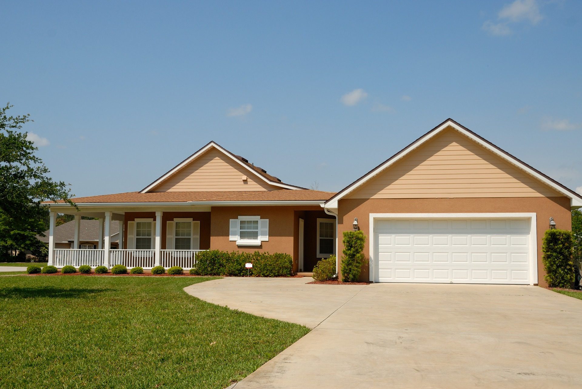 An image of yellowish brown house with lawn in front of it. Oceans Managing Group can provide property management for a property like this